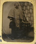 HALF-PLATE TINTYPE OF UNIDENTIFIED SOLDIER IN MOUNTED GREAT COAT